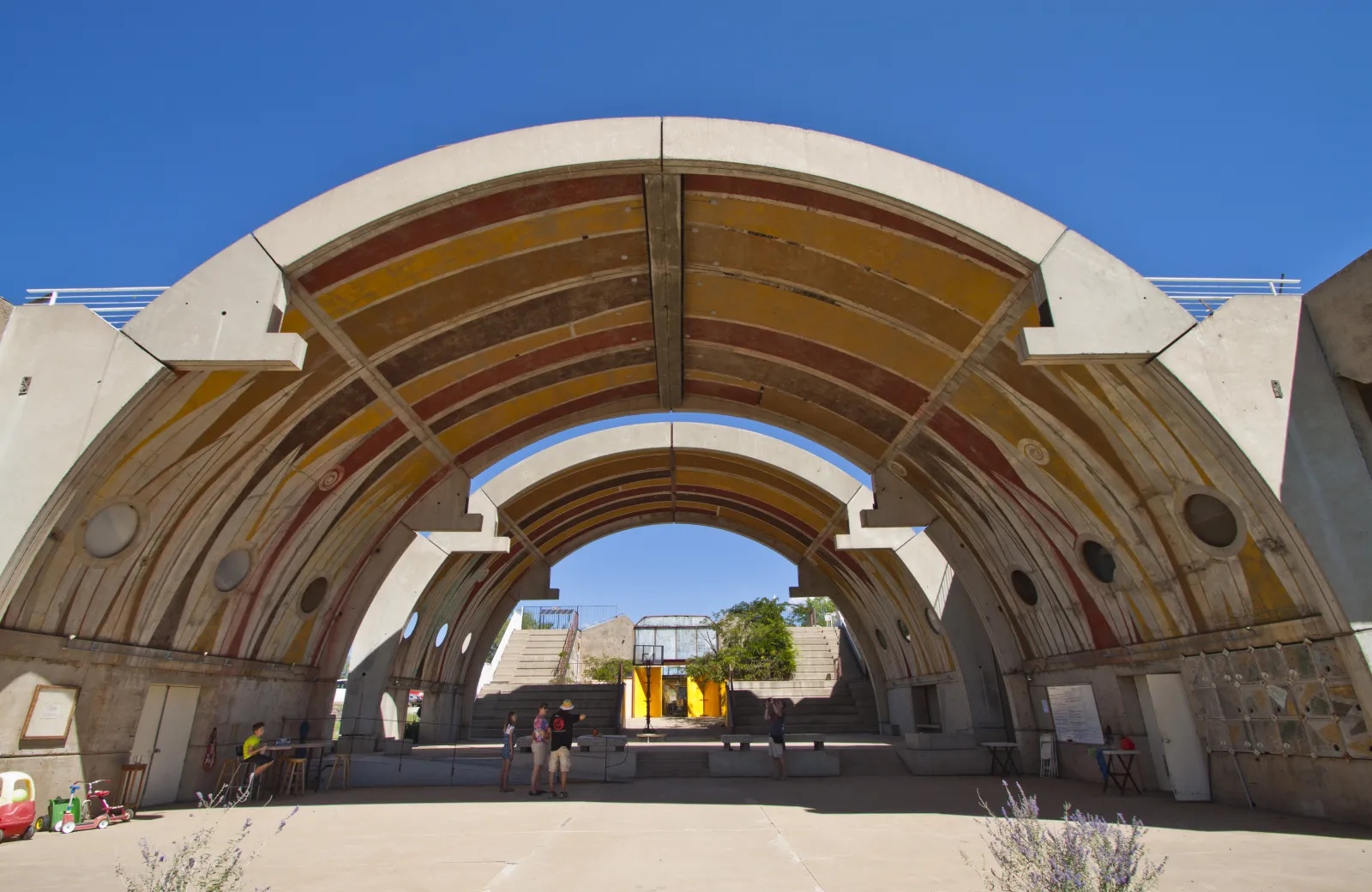 The iconic concrete vaults of Arcosanti — monumental arched structures against desert sky
